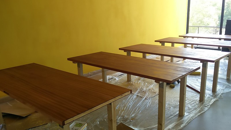 Our lovely yellow wall and our lovely DIY tables.